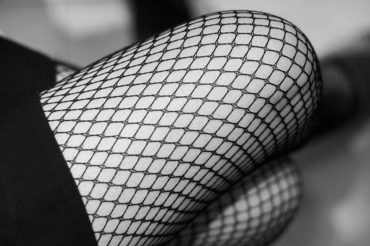 Close-up of stretchy climbing tights showing reinforced knee panels and flatlock seams