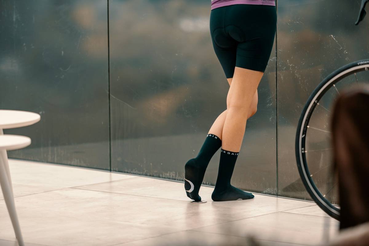 Woman cycling in rain wearing warmest cycling tights australia with fleece lining and reflective details